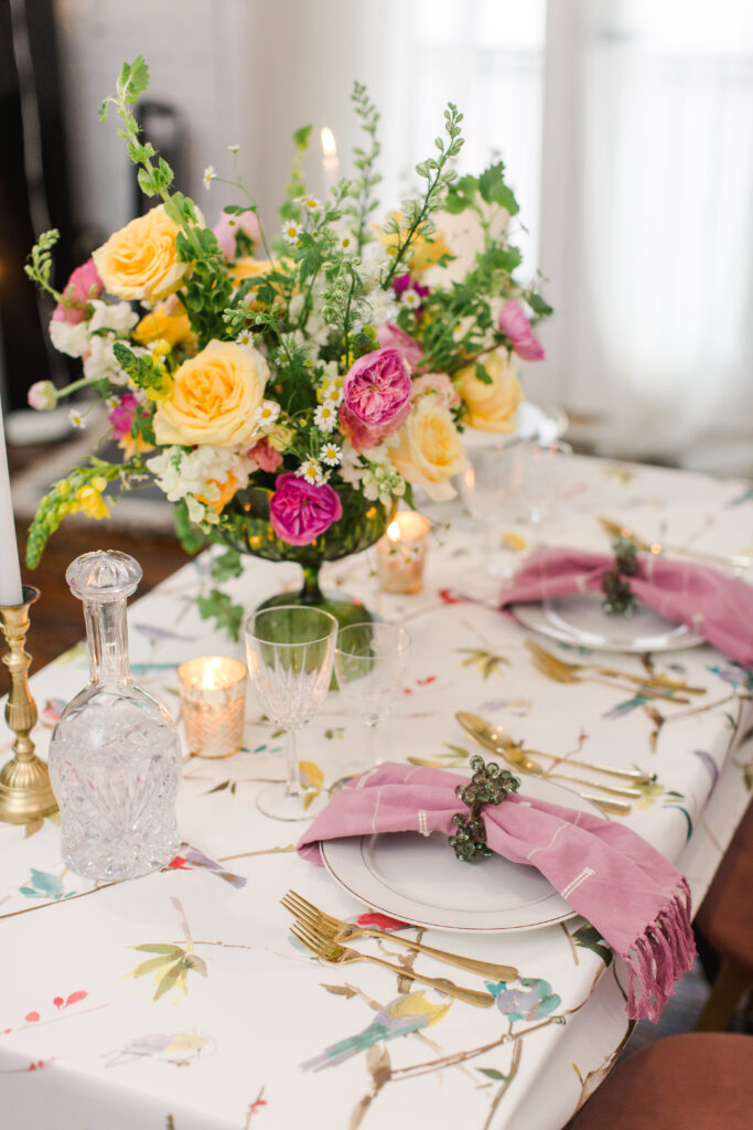 Sweetheart wedding table with summer color palette of flowers in pink, yellow and white