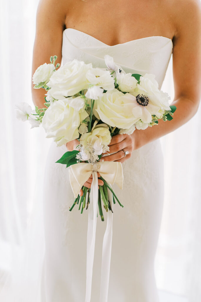 bride holding all white bouquet