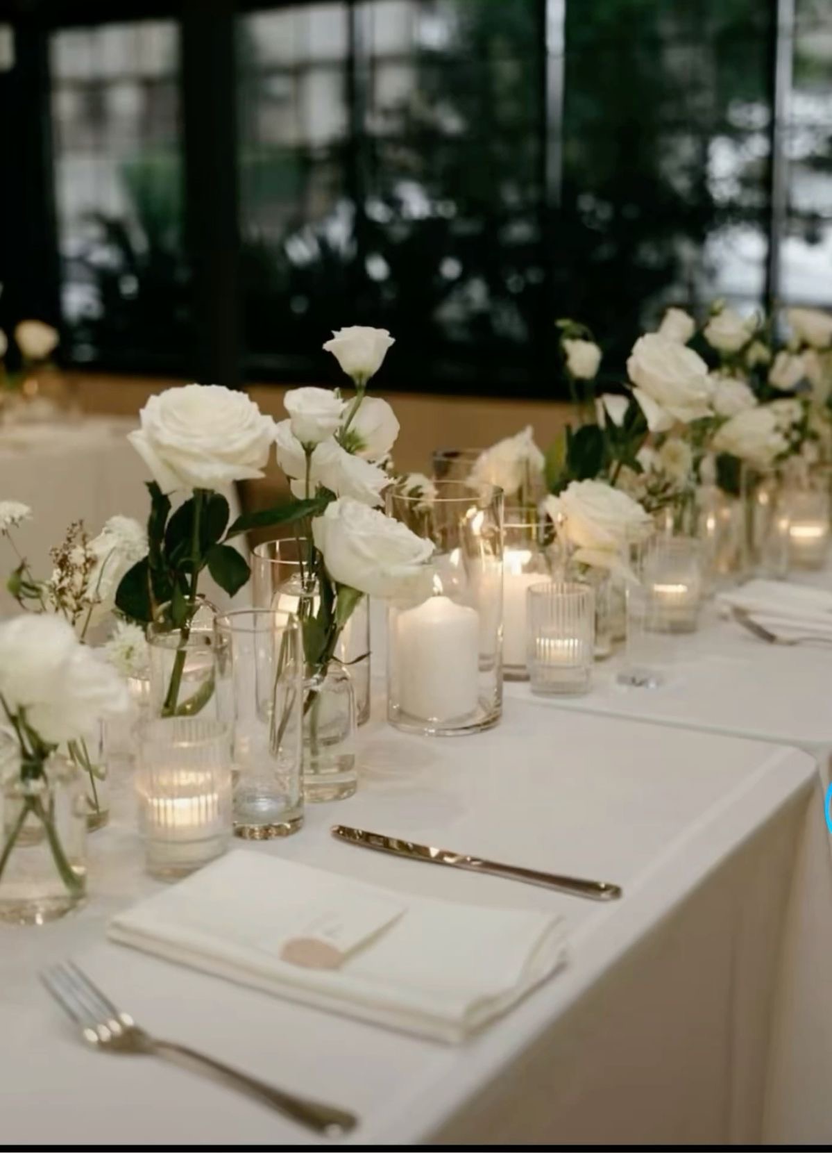 Wedding table with candles and white flowers.